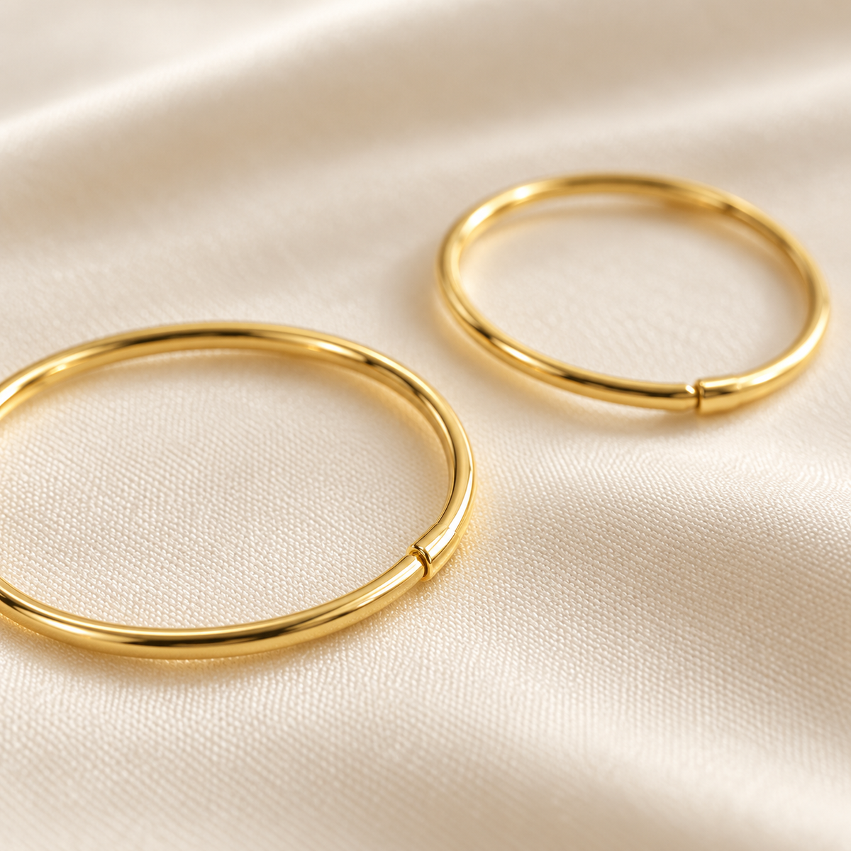Gold-plated sterling silver hoop close detail, digital visualisation on ivory silk