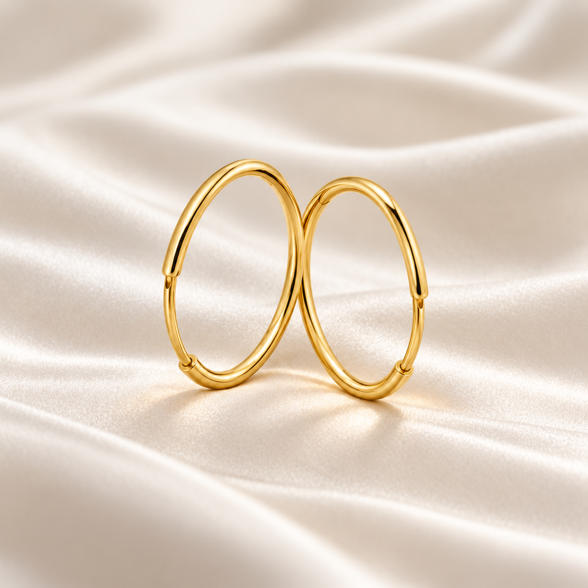 15mm gold-plated hoop pair standing, digital visualisation on ivory silk