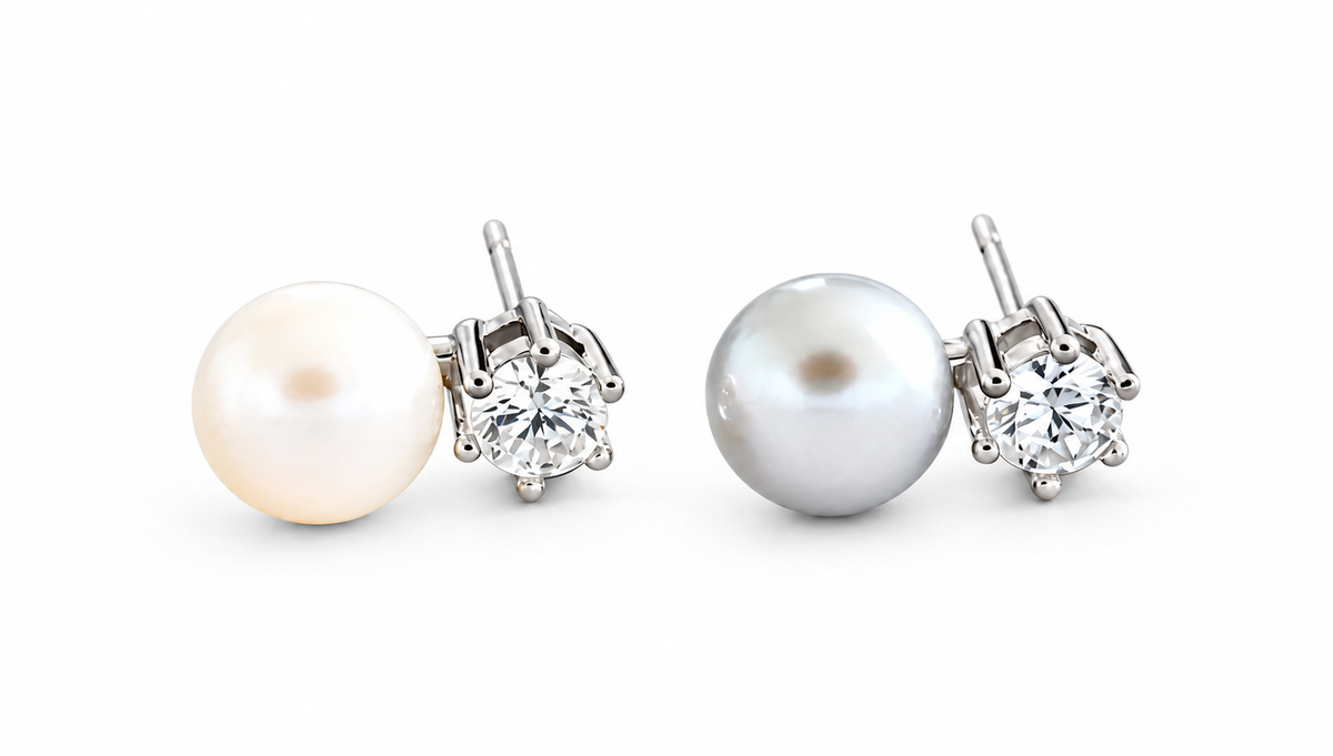 Pearl and clear CZ silver stud earrings on white studio background