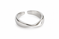 Sculpted crossing silver ring on white studio background