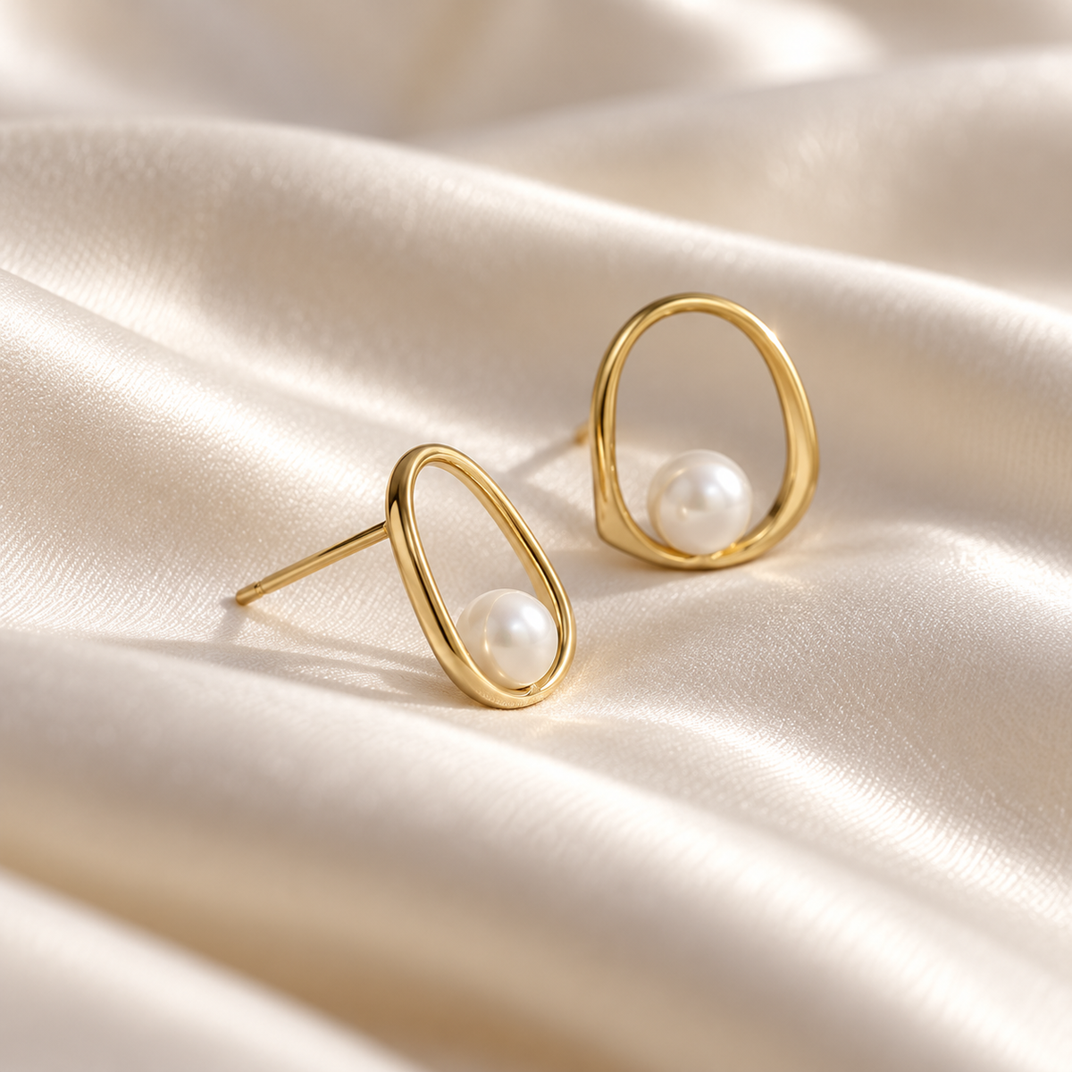 Digital studio visualisation of Yellow Gold shell pearl studs on ivory silk, three-quarter profile