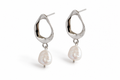 Silver open teardrop pearl earrings on white studio background